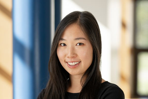 Photo of Elaine Yao smiling looking directly at camera in a black long sleeve top