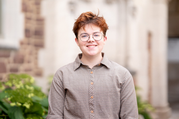 Photo of Niko Dawson smiling in a button up shirt