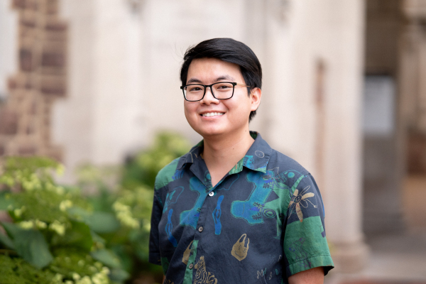 Photo of Thanh David Nguyen smiling in a multi-colored button up shirt