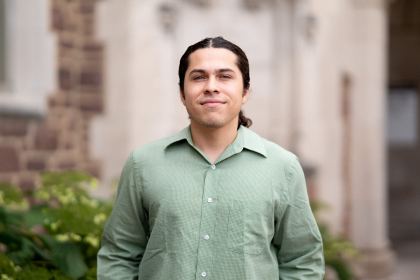 Photo of Jose Santiesteban smiling in a green button-up shirt