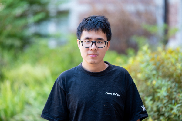 Photo of Bort Wu in glasses wearing a black t-shirt