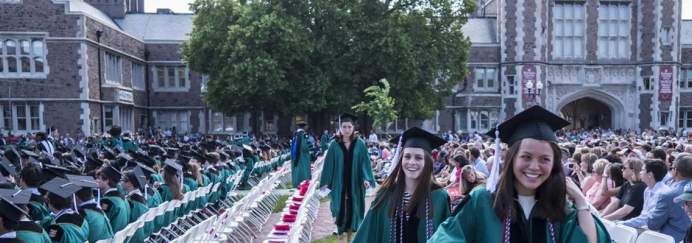 students in caps and gowns at graduation