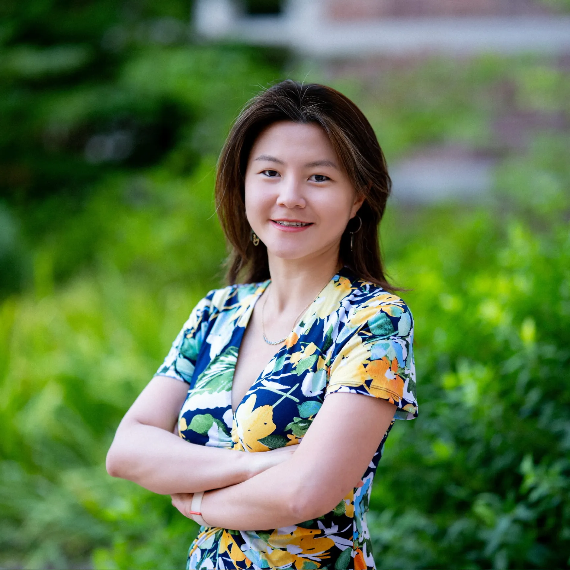 Photo of Victoria Shen smiling to the camera with arms crossed in front of her chest.