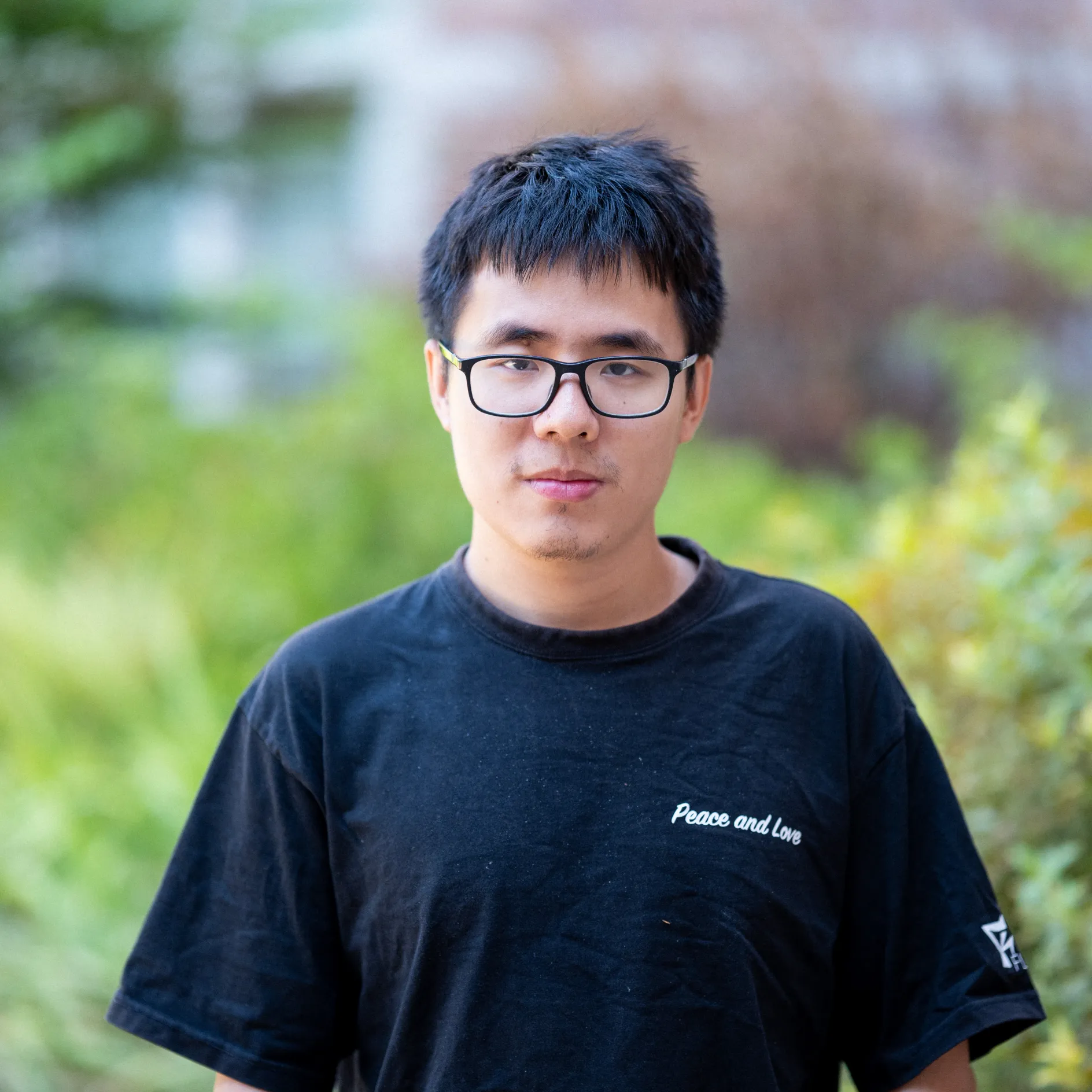 Photo of Bort Wu in glasses wearing a black t-shirt
