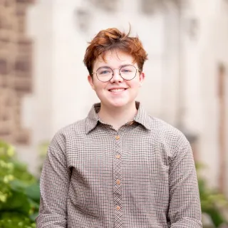 Photo of Niko Dawson smiling in a button up shirt