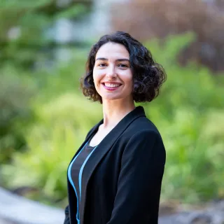 Photo of Zeynep Ceren smiling in a black jacket and black top