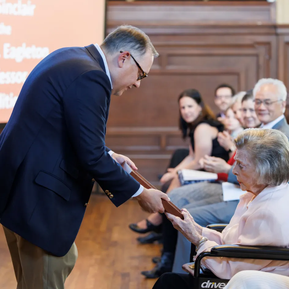 Photo of Andrew Martin showing the Thomas F. Eagleton medal to Barbara Ann Smith Eagleton
